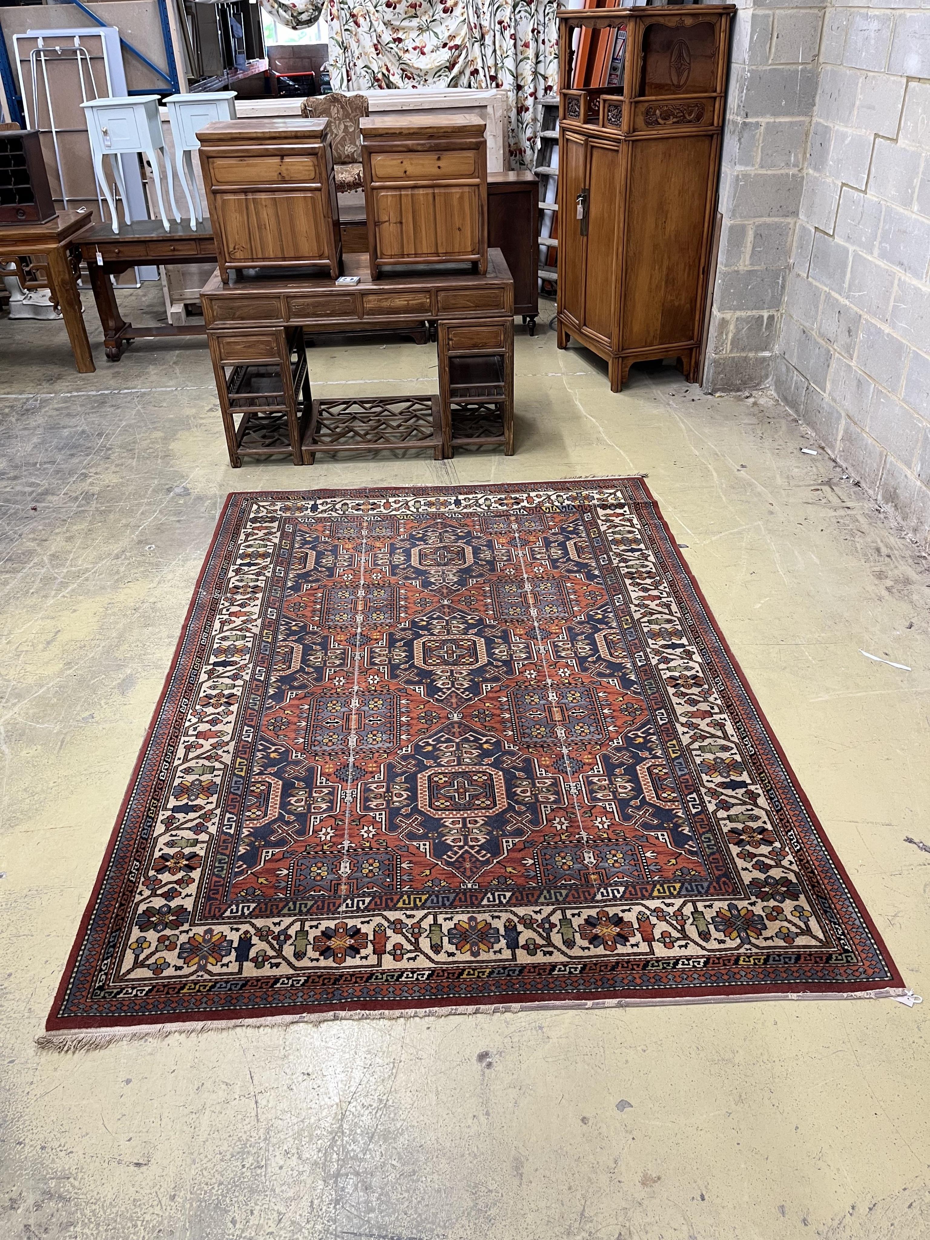 A Caucasian style red ground machined carpet, 275 x 192cm. Condition - poor